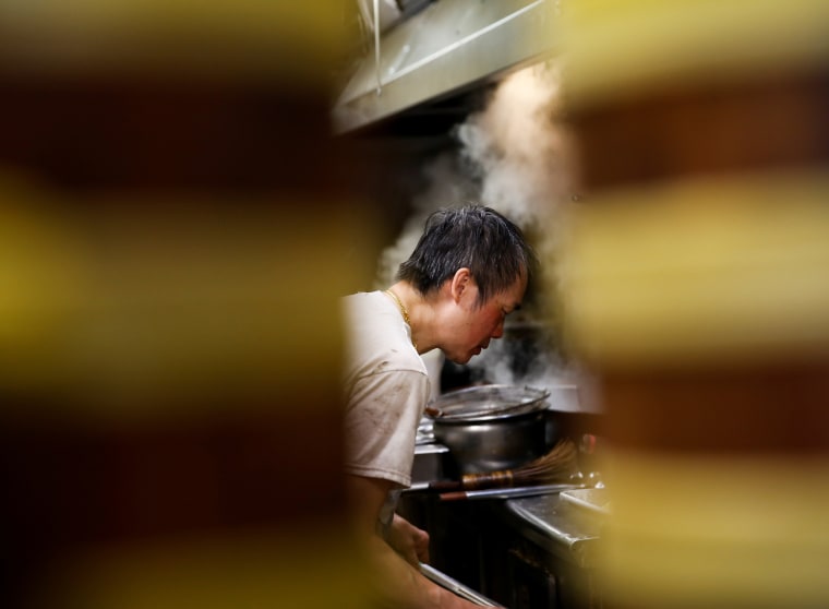 Image: Mr. Chan cooks at Jade Garden Restaurant in Seattle's Chinatown-International District, as the business moves to takeout-only due to new state restaurant requirements during the outbreak of coronavirus disease (COVID-19), in Seattle