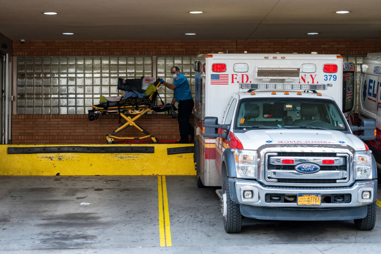 Image: A person is transported from an ambulance to the emergency room at Wyckoff Heights Medical Center on April 7, 2020 in New York.