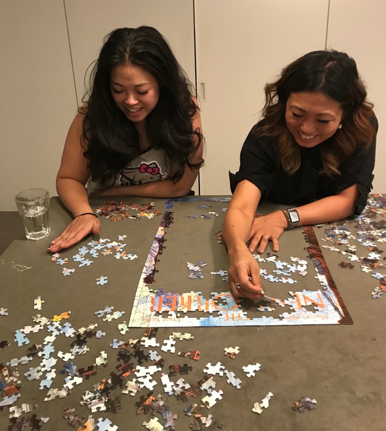Jane Park and Lisa Sun having a girlfriends night in of takeout and puzzles.