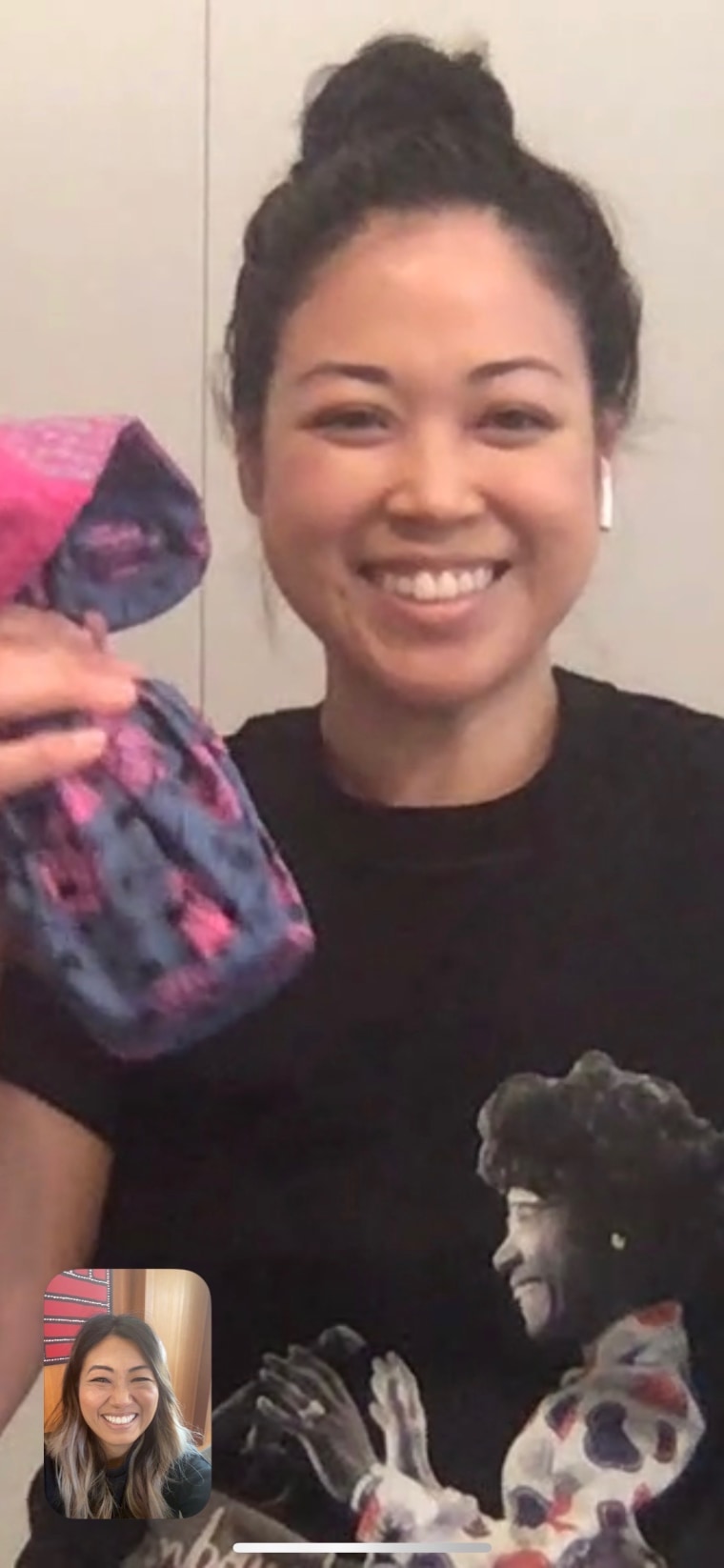 Lisa holding a mask while on FaceTime with Jane.
