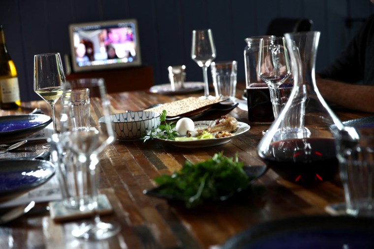 Image: Sarah and Aaron Sanders celebrate a Passover Seder with their children, Noah, 19, Bella, 18 and Maya, 13, at home and different family members across the country via video conference