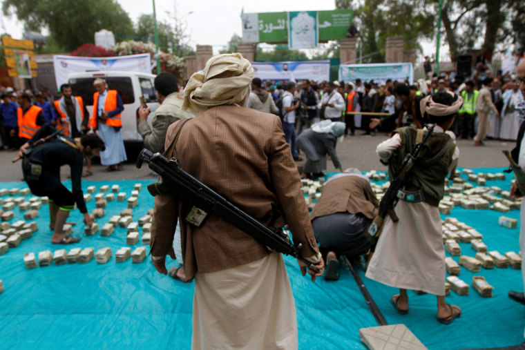 Image: Houthi supporters carry weapons during a gathering in Sanaa