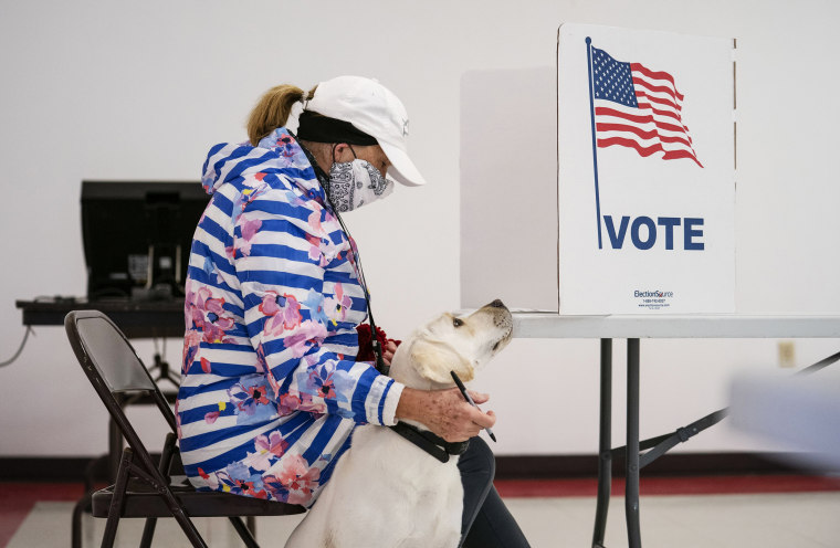 Image: A woman votes in the Wisconsin Primary in Superior, Minn.