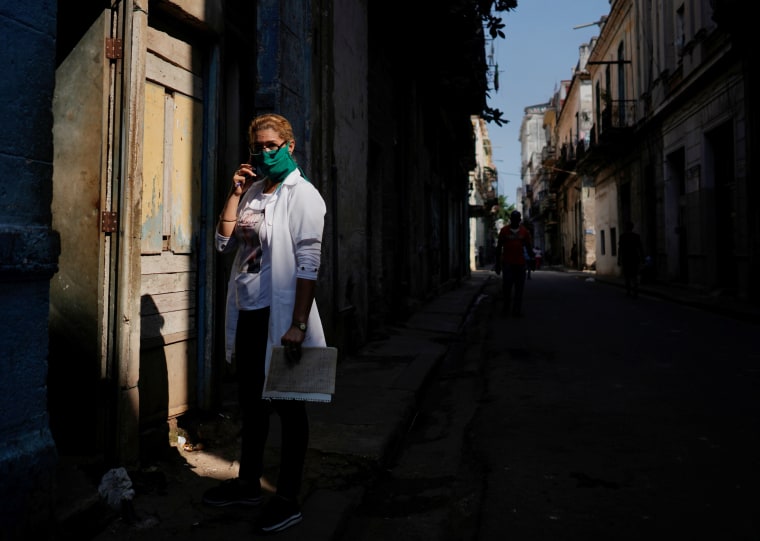 Image: Health worker Mari Garcia waits to check a family in downtown Havana
