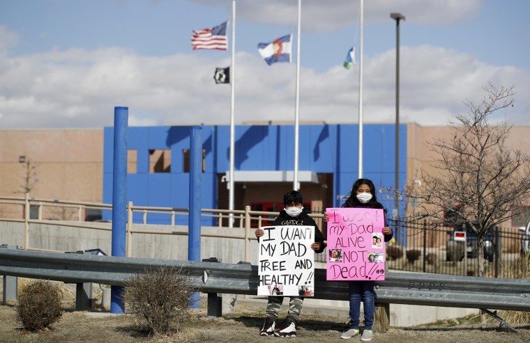 Image: Children hold signs in protest with Abolish ICE Colorado outside the GEO Detention Center in Aurora on April 3, 2020.