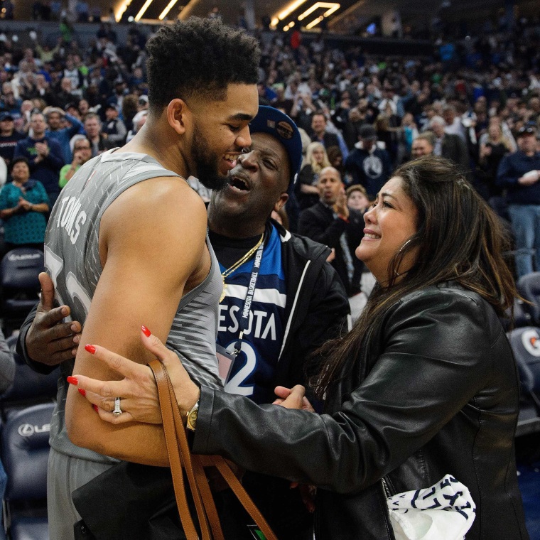 Karl-Anthony Towns hugs his parents, Karl and Jackie Towns, after winning a game against the Denver Nuggets on April 11, 2018 at the Target Center in Minneapolis.