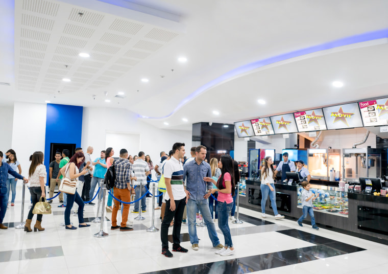People buying food at the cinema before watching a movie