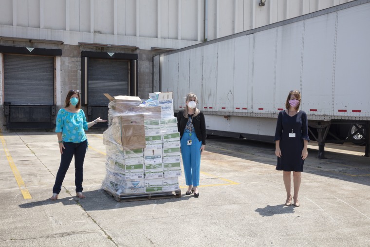 Rebecca Talaia with Ana Sanchez, a representative of Health First's distribution center, and Tina Descovich, a member of the Brevard County, Florida school board.