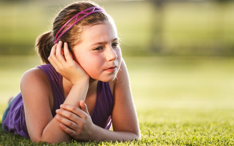 girl laying in grass