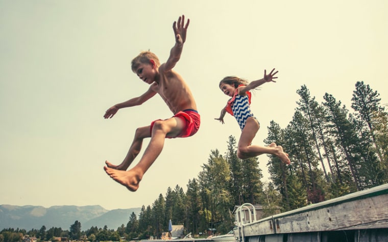 kids jumping into lake