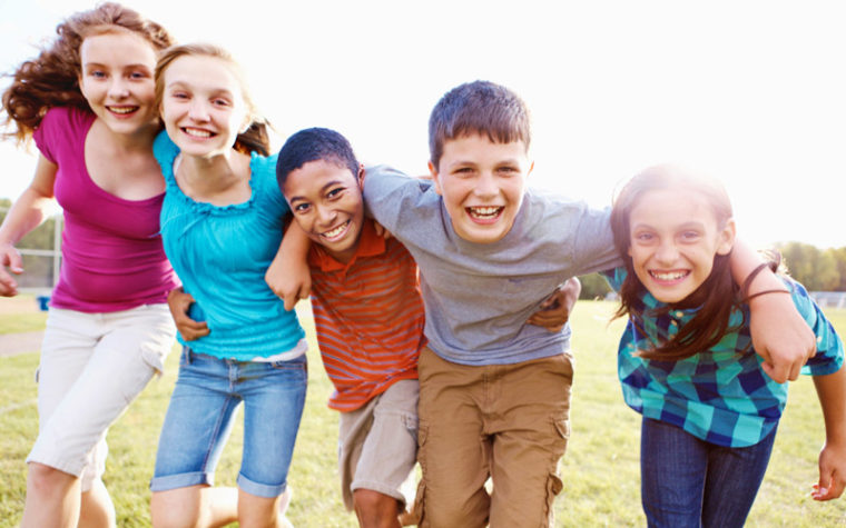 Young teen group laugh outside