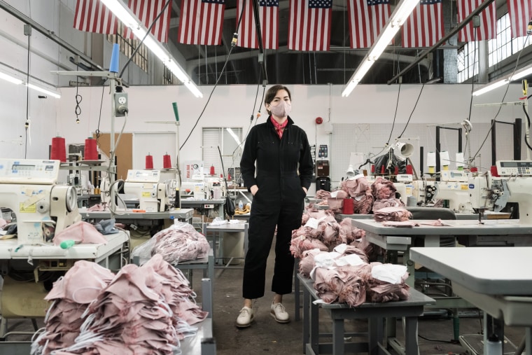Bennett surrounded by masks on her factory floor.