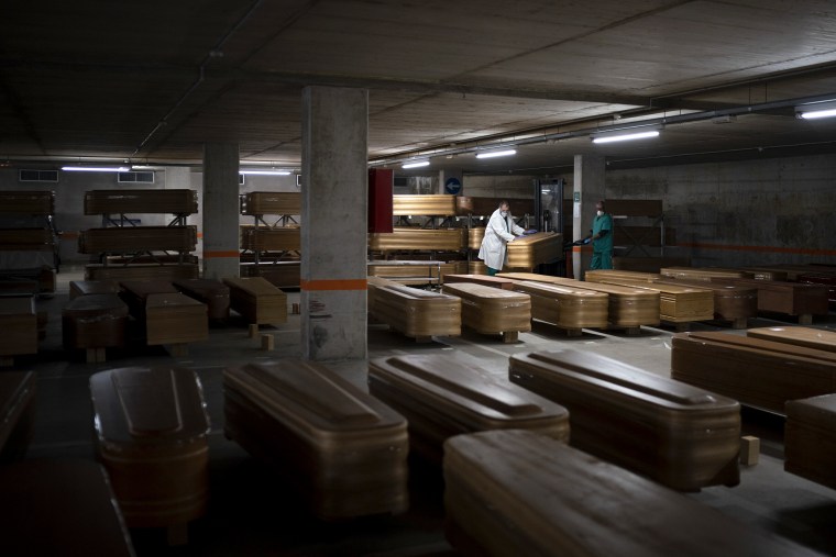 Image: Coffins carrying the bodies of people who died of coronavirus are stored waiting to be buried or incinerated in an underground parking lot at the Collserola funeral home in Barcelona, Spain on Thursday.