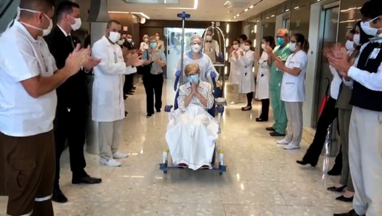 Image: 97-year-old Gina Dal Colleto, the oldest known survivor of coronavirus in Brazil, leaves the hospital to applause and cheers from doctors and nurses on April 12, 2020.