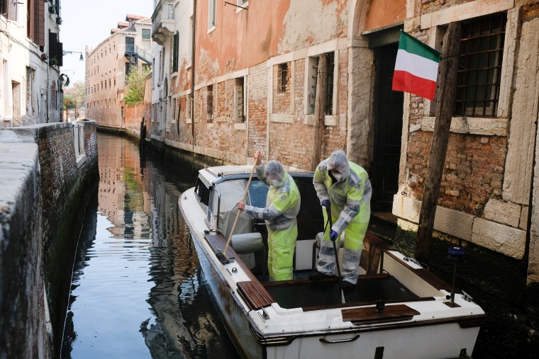 Image: Municipal workers wearing protective gears sanitize a boat as the Italian government allows the reopening of some shops while a nationwide lockdown continues following the outbreak of the coronavirus disease (COVID-19) in Venice