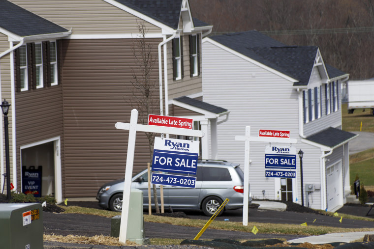 Model homes and for sale signs line the streets in Zelienople, Pa., on March 18, 2020.