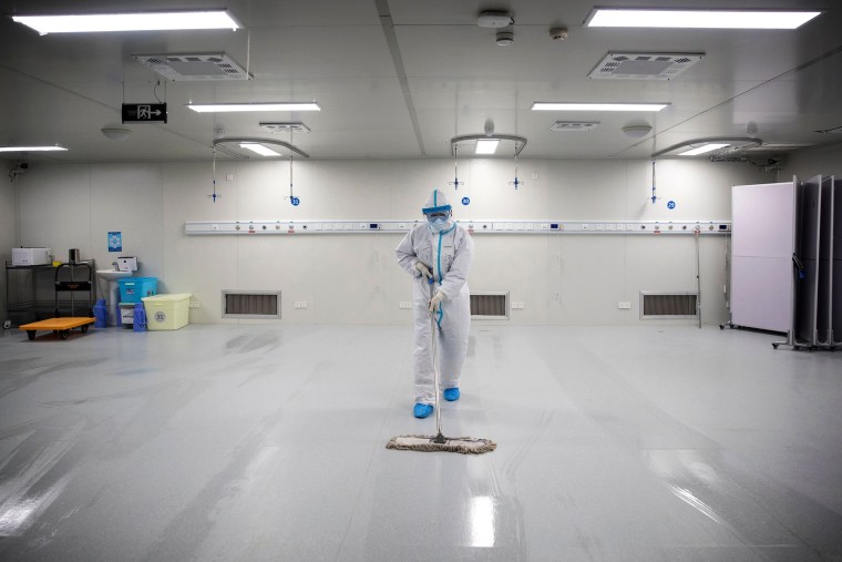 Image: A staff member cleans the floor after the last patients were discharged from Leishenshan Hospital, originally built to treat people infected with COVID-19, in Wuhan on Tuesday.
