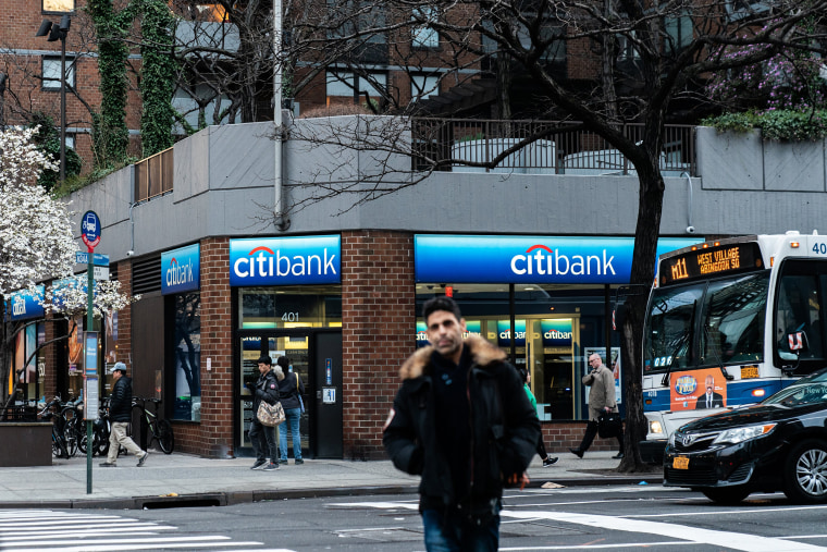 Image: People walk past Citi bank branch in New York
