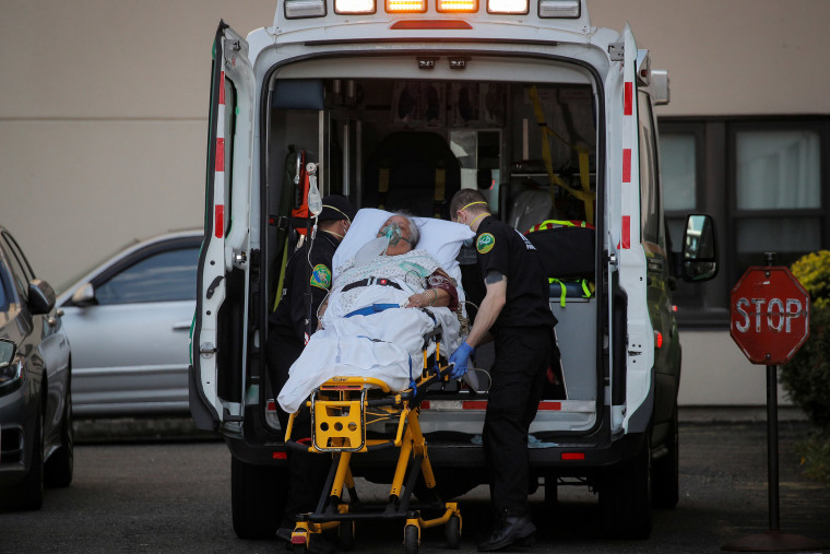 Image: A woman is loaded into an ambulance by paramedics Chateau at Brooklyn Rehabilitation & Nursing Center during the outbreak of the coronavirus disease (COVID19) in Brooklyn, New York