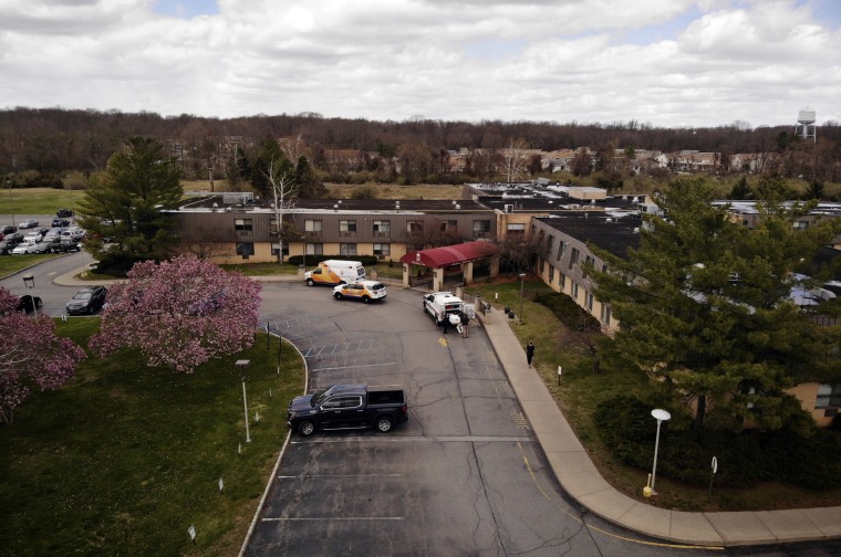 Image: Ambulance and medical crews outside of Andover Subacute and Rehabilitation Center in New Jersey after police found more than a dozen bodies on April 16, 2020.