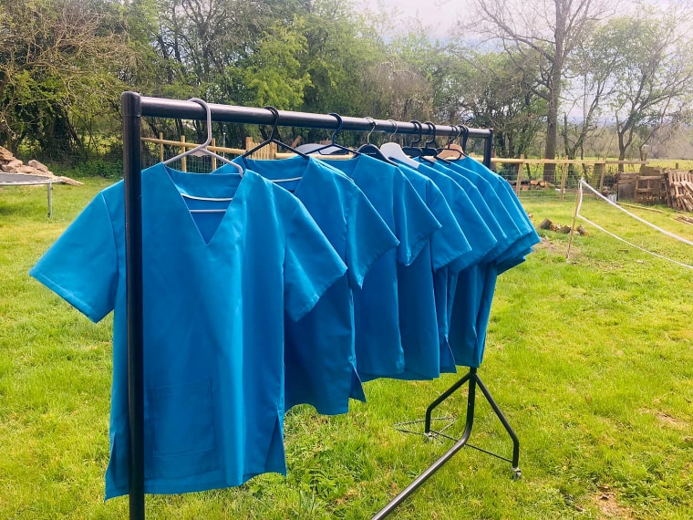 Image: A sample of finished scrub tops for returning medics and those clinicians who do not normally wear the outfit.