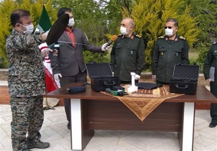 Islamic Revolutionary Guard Corps officers present what they say is a device capable of detecting coronavirus, April 15, 2020.