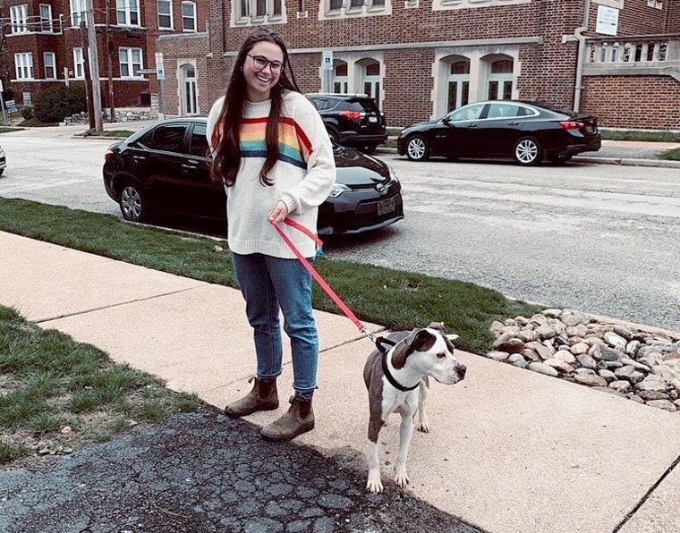 Megan Lemaire takes her foster dog, Vorhees, on a walk in St. Louis. Vorhees has lived with Megan and her roommate for three weeks.