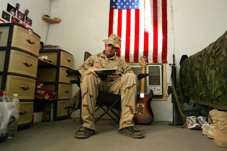U.S. Army Sgt. George Scheufele fills out an absentee ballot while voting in the American presidential and congressional election while at Camp Eagle in Baghdad, Iraq, on Oct. 6, 2004, ahead of the Nov. 2 polls in the United States. Scheufele, 24 and voting for the first time, said that the military's voter registration drive had made it easy for him to participate.