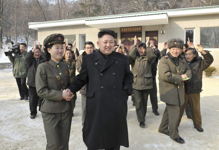 Image: North Korean leader Kim Jong Un shakes hands as he visits the revolutionary battle site in Mt. Madu
