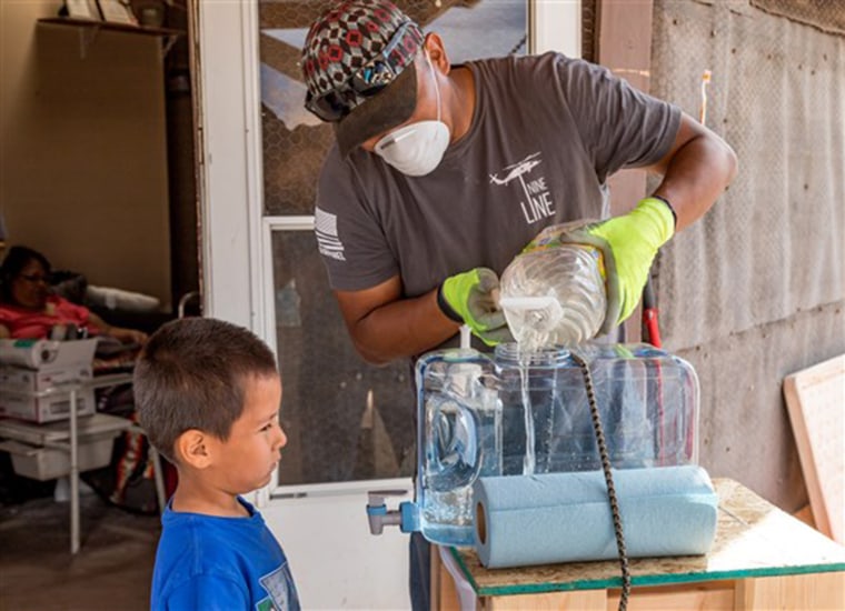 Diante, 8, washes his hands at a hand-washing station installed by a volunteer for the Center for American Indian Health at Johns Hopkins University's Bloomberg School of Public Health. The center is installing hand-washing stations in Chinle, Ariz., where many homes do not have access to running water.