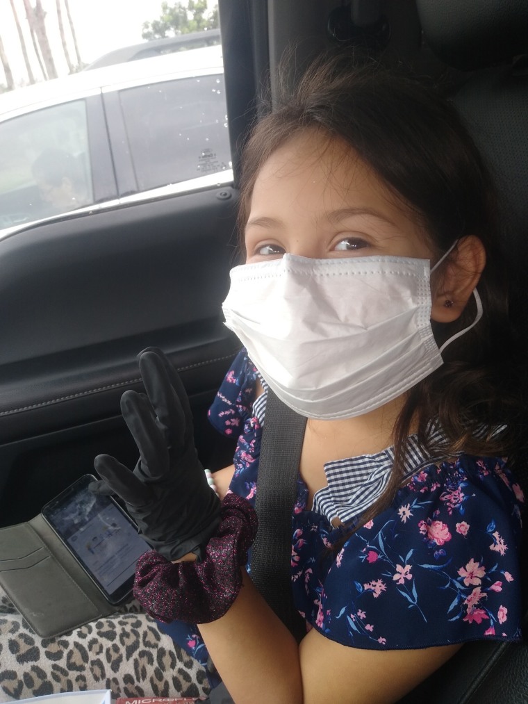 MaryAnn Resendez makes sure her daughter is wearing a mask when they leave the house.