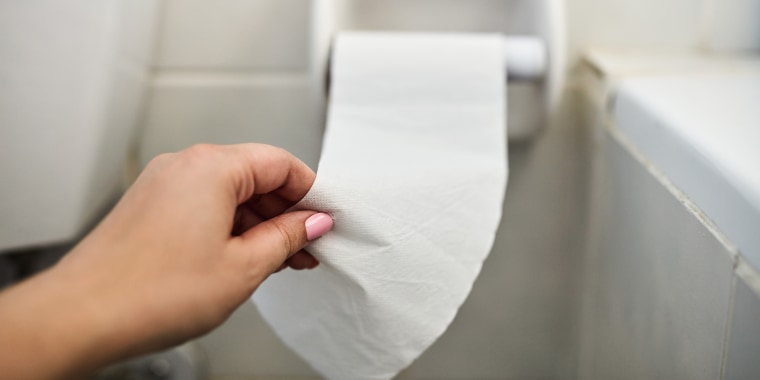 Cropped shot of an unrecognizable woman reaching for toilet paper