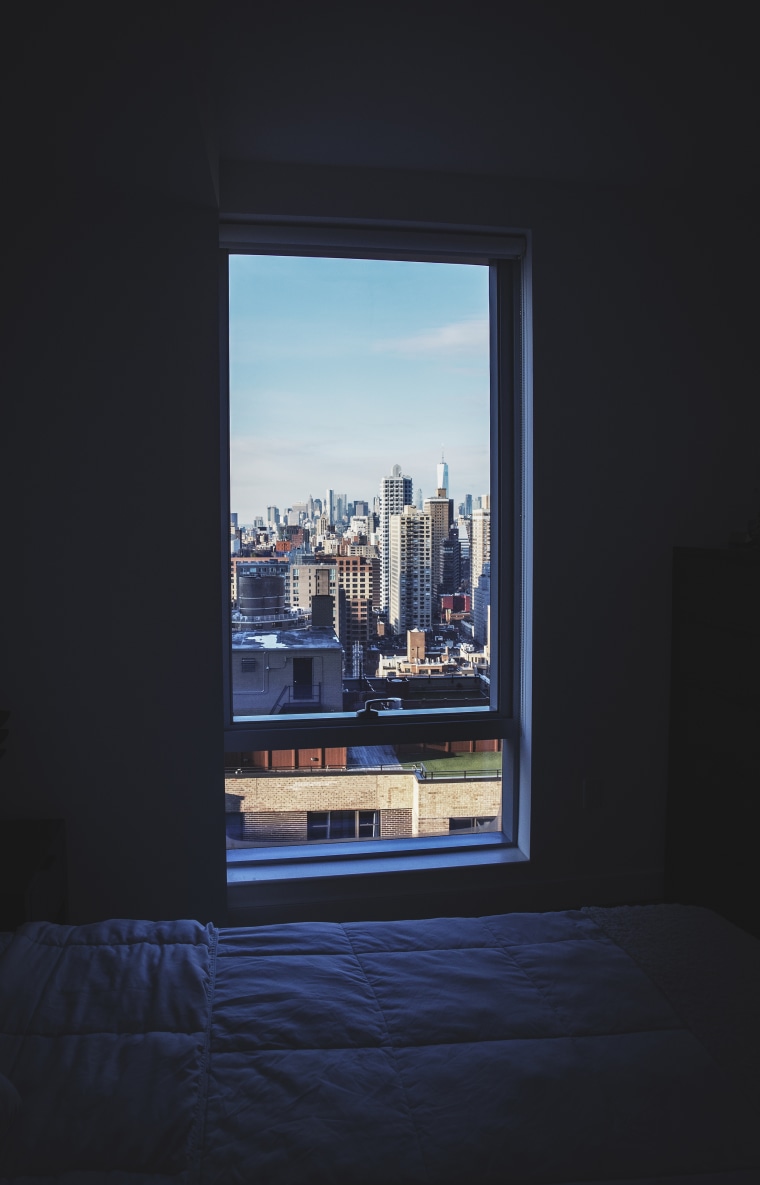 New York, Manhattan cityscape outside a dark room window