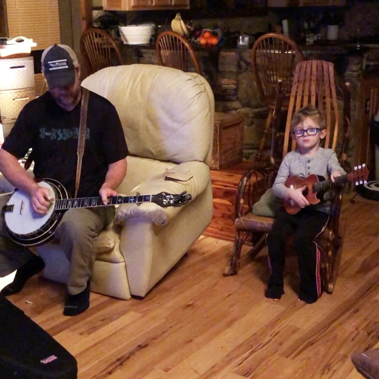 Tyler and Barry Abernathy practice playing music together.