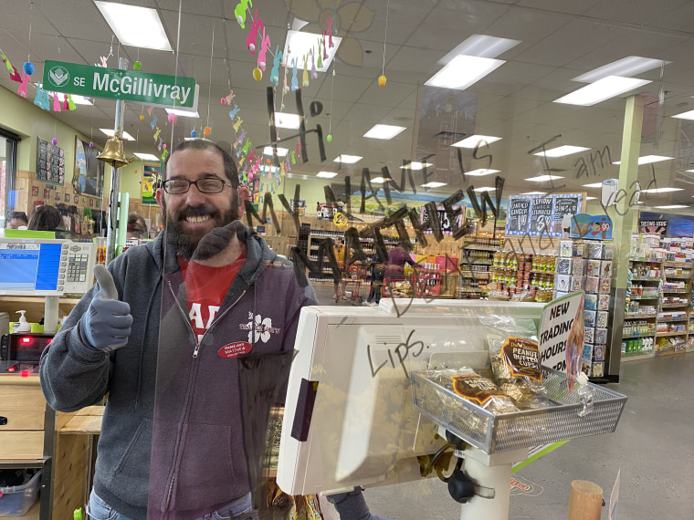 Matthew Simmons is pictured working the Trader Joe's register at his store in Vancouver, Washington.