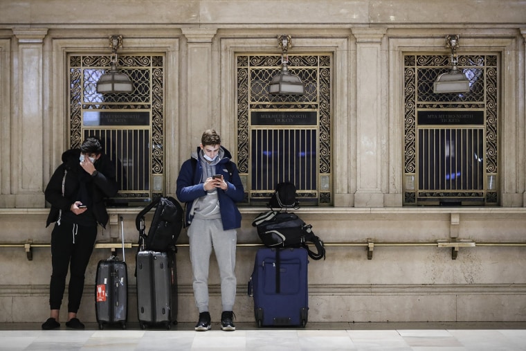 Image: Travelers on their smartphones at Grand Central Terminal in New York