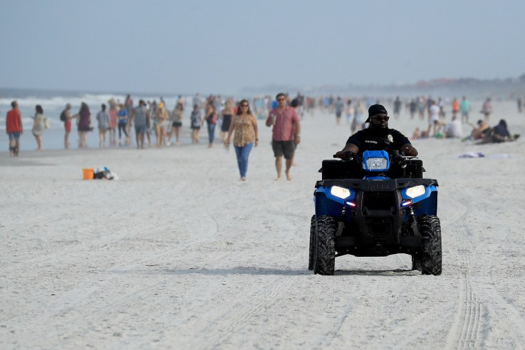 Image: JPolice drive down the beach on April 19, 2020 in Jacksonville Beach, Florida