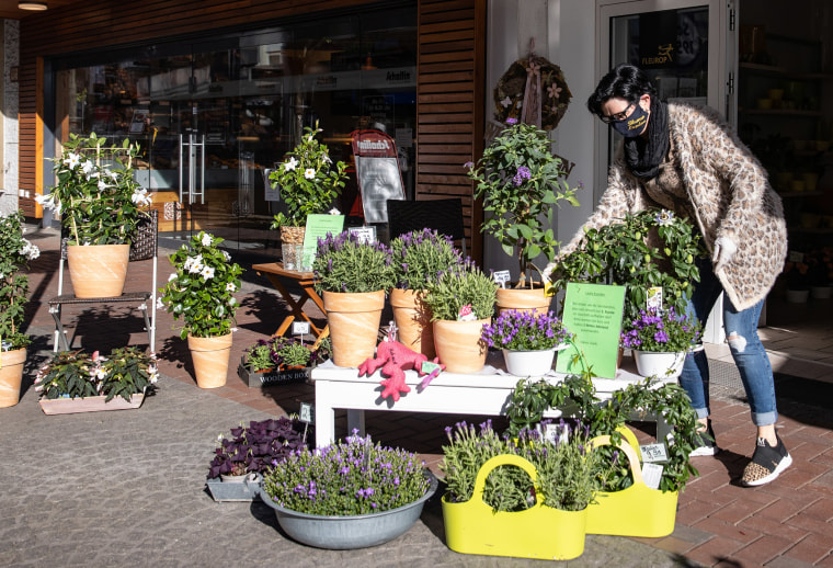 Image: A florist in Dinslaken, Germany sets up her shop as the country eased some restrictions it put in place during the coronavirus.