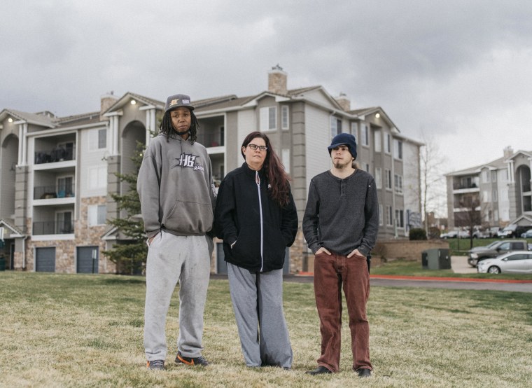 Kendra Tallant, 41, her fiance, BJ Shepherd, 35, and her son Jonathyn Murray, 23, outside of their apartment complex in Colorado Springs.