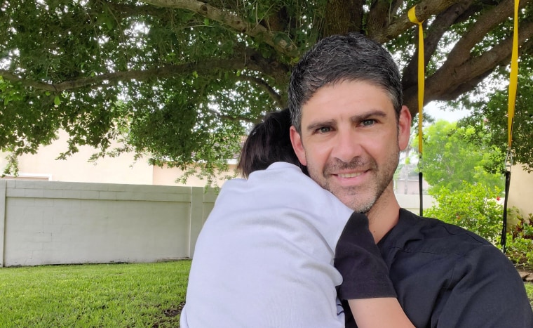 Dr. Christian Assad hugs his five-year-old, Kian. Assad is a cardiologist, not an emergency room physician, but when Kian fell and split his head open, Assad relied on his medical background to treat Kian at home instead of risking exposing his family to the coronavirus in a hospital.