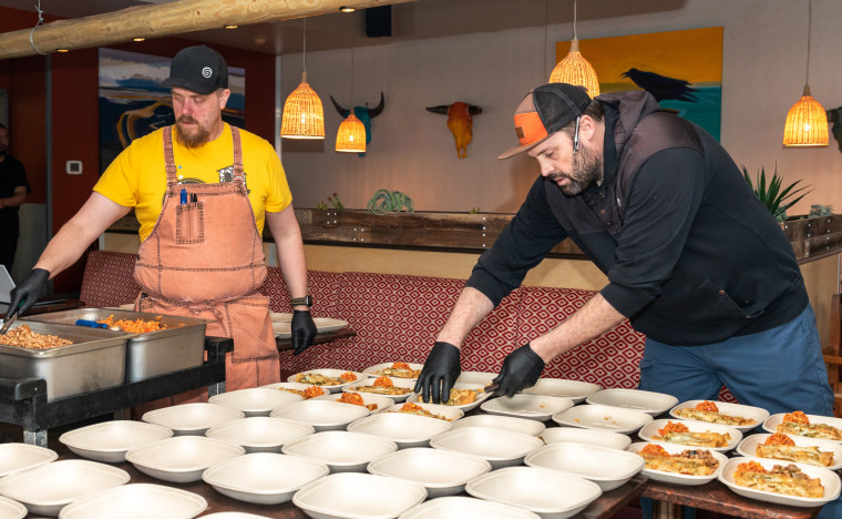 Chef Kyle Mendenhall, right, prepares enchiladas at Zolo Grill in Boulder.