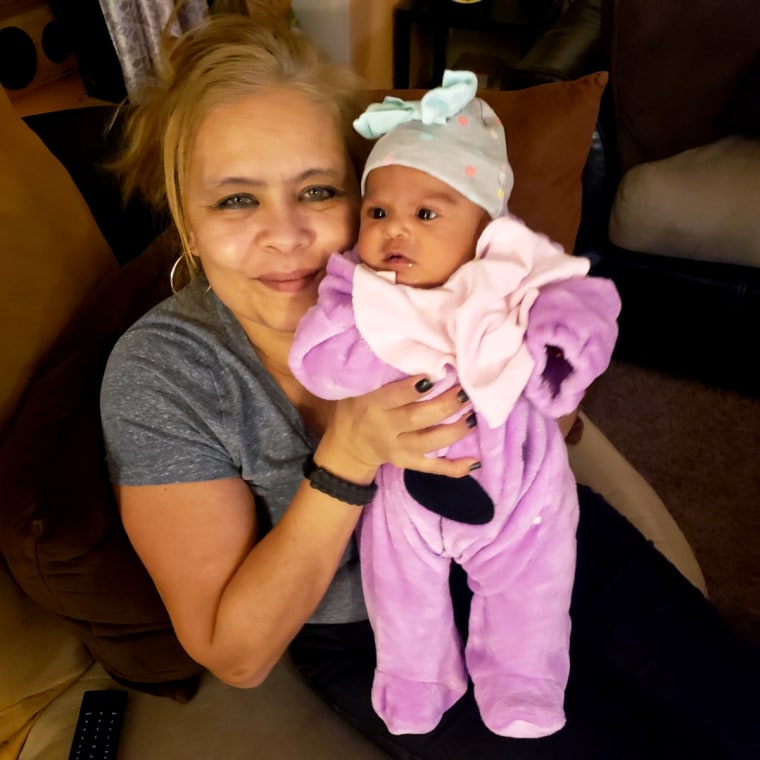 Image: Wanda La Santa holds her granddaughter, Jay-Natalie.
