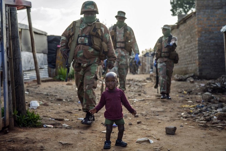 Image: South African National Defense Forces patrol the Sjwetla informal settlement after pushing back residents into their homes on April 20, 2020.