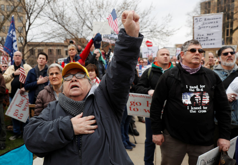 Image: Demonstrators protest the extension of the emergency Safer at Home order by State Governor Tony Evers to slow the spread of the coronavirus disease (COVID-19), outside the State Capitol building in Madison, Wisconsin