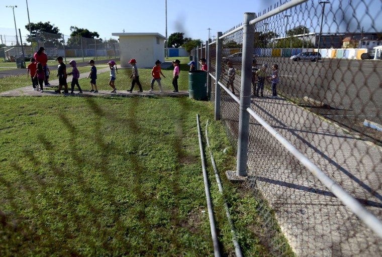 Kindergarten students from the Martin G. Brumbaugh School are led by their teacher to the race track for exercise in Santa Isabel, Puerto Rico on Feb. 4, 2020.