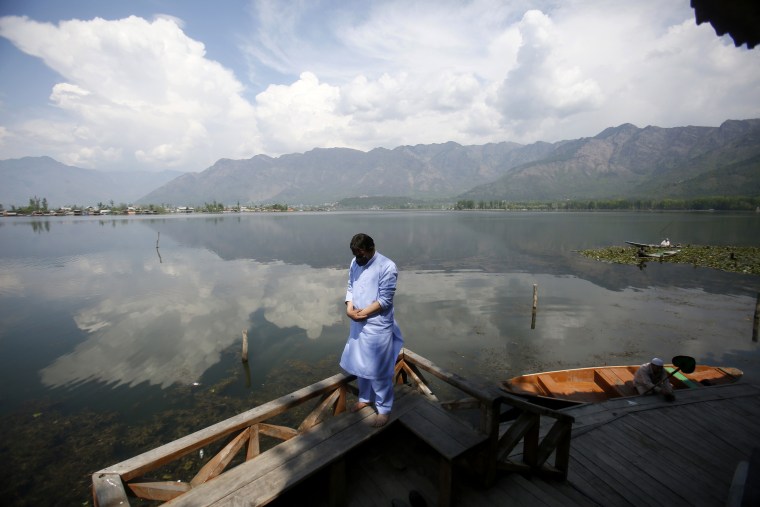 A Kashmiri Muslim man offers prayer on the banks of Dal Lake on the second day of Ramadan during lockdown in Srinagar, Indian controlled Kashmir on Sunday. Kashmiri shrines usually packed with devotees during the holy month of Ramadan were deserted as authorities closed the shrine for public safety.