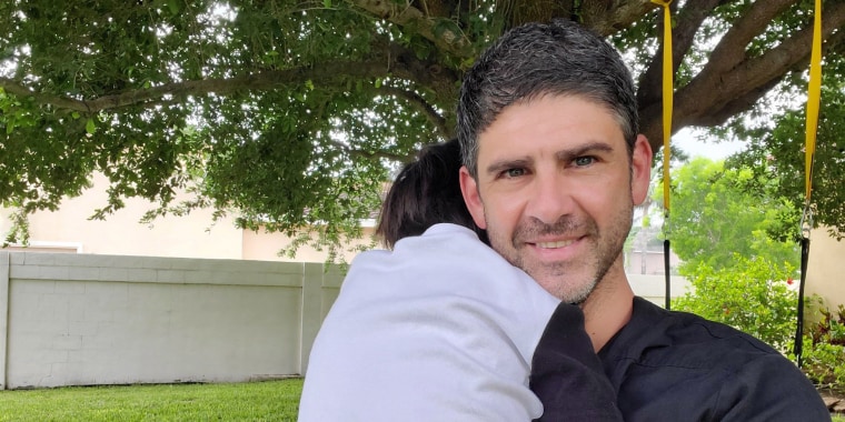 Dr. Christian Assad hugs his 5-year-old, Kian. When Kian fell and split his head open, Assad relied on his medical background to treat Kian at home instead of risking exposing his family to the coronavirus in a hospital.