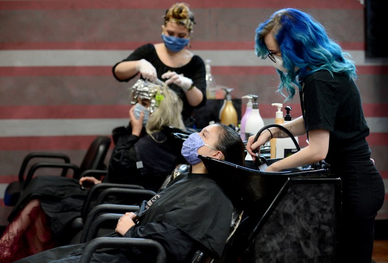 Image: Customers wear masks at a salon in Marietta, Ga., after the state reopened businesses and restaurants after restrictions to curb the spread of coronavirus on April 24, 2020.