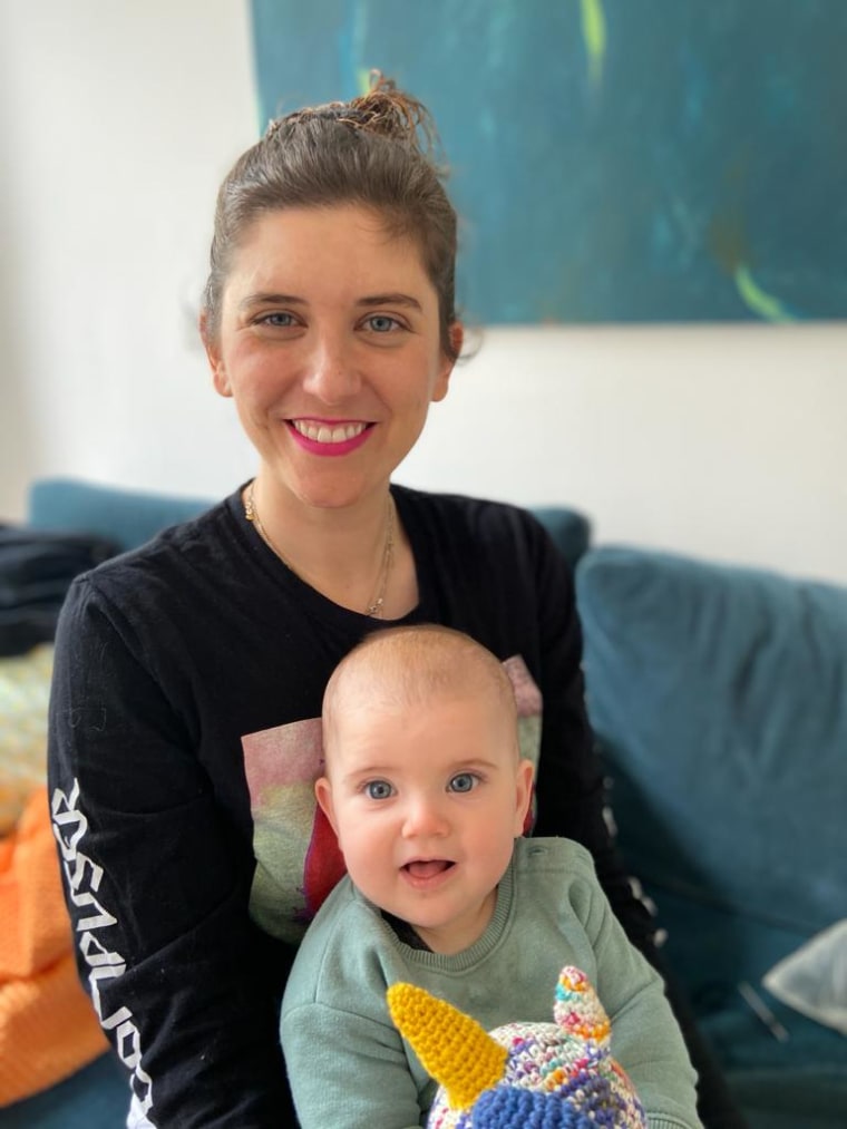 Image: Kaitlin Mellini, 34, and her 8-month-old daughter Zoe, enjoyed their first stroll outside together since mid-March on Sunday.