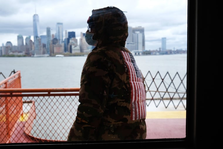 Image: People ride the Staten Island Ferry, which commutes between Staten Island and Manhattan